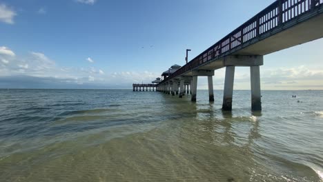 waves rolling underneath florida fort myers pier, beach us