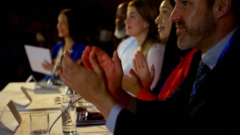 Happy-multi-ethnic-business-people-applauding-in-business-seminar-in-auditorium-4k