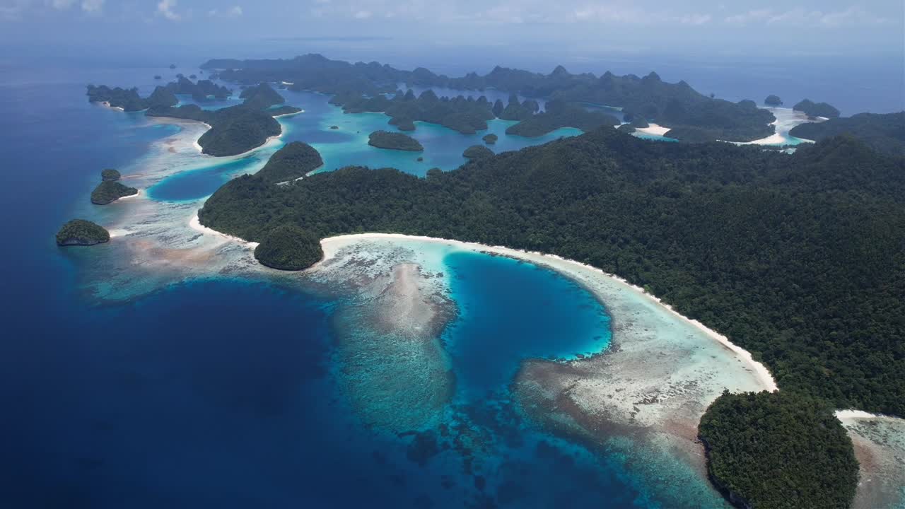 high altitude stunning view on many islands, white sandy beaches, lush green flora, coral reefs in Raja Ampat, Wayag, Indonesia