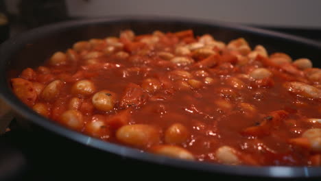 cooking white beans with tomato sauce and vegetables