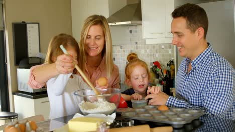 Parents-teaching-their-kids-to-prepare-the-dough-in-the-kitchen-4k