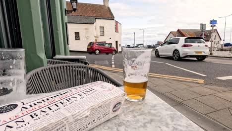 a pint of beer on a street table