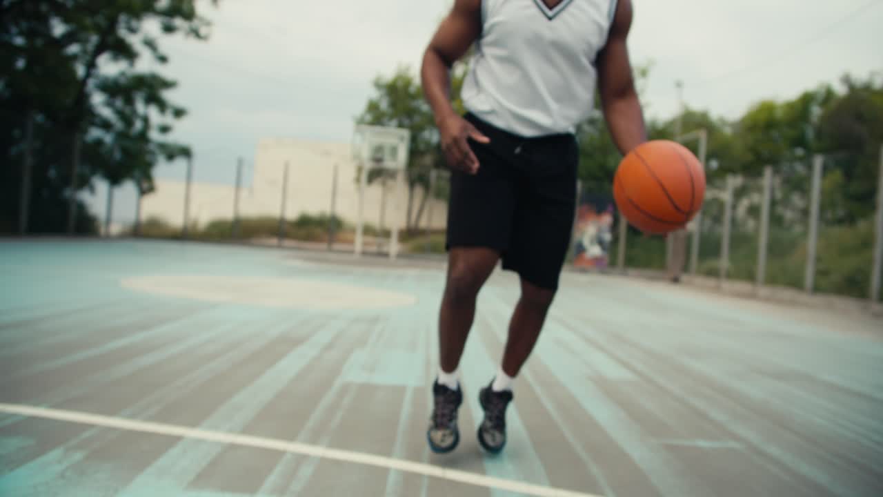 A dynamic game of multi-racial company basketball. A group of friends quickly pass the ball to each other to win the basketball game