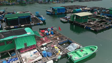 aerial over the fishing boats and rafts of the fish farms on ma wan island, hong kong, china