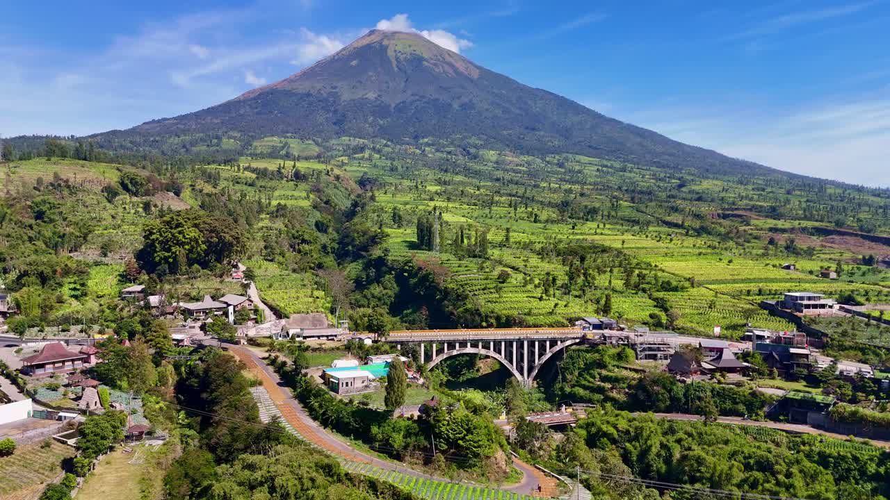 Sigandul Bridge with Mount Sindoro in the background in Temanggung, Indonesia, aerial view