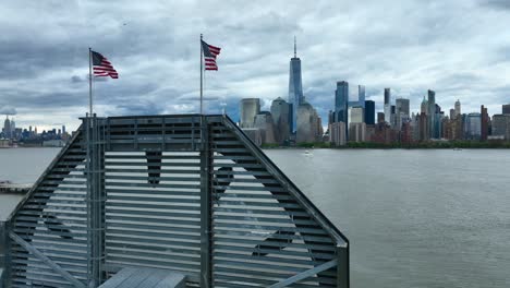 lower manhattan skyline with two american flags