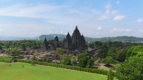 aerial drone view of prambanan hindu temple site surrounded by garden, indonesia