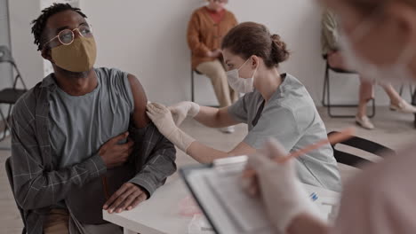 Woman Injecting African Man