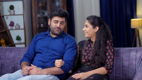 a cheerful indian husband-wife together at their home - a romantic couple, togetherness and bonding