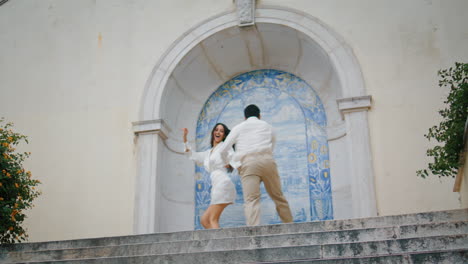 Aufgeregte-Liebende-Laufen-Treppen.-Positiver-Mann-Und-Frau-Halten-Händchen-Im-Azulejo-Platz