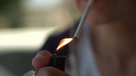 mujer encendiendo un cigarrillo en cámara super lenta en verano