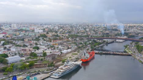 luxurious yacht moored in don diego harbor with santo domingo city in background, dominican republic