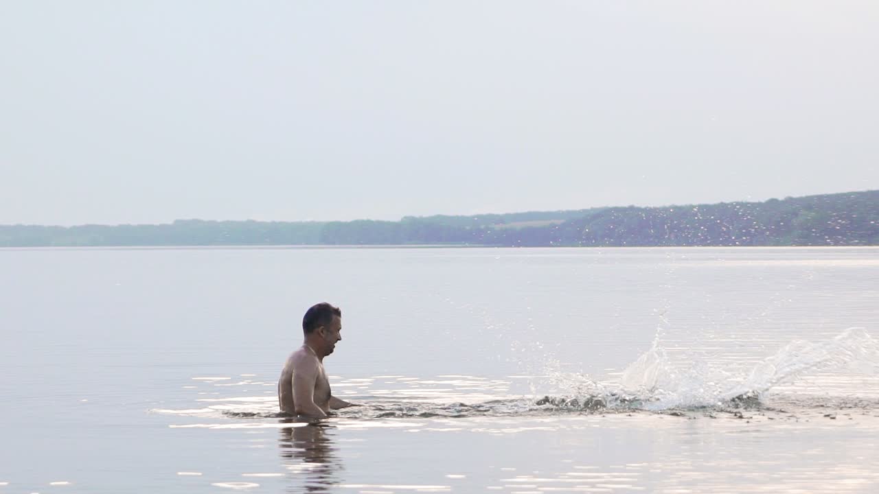 Jumping in the water. Man and boy are having fun and splashing in the water. Summer holiday concept