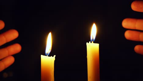 two-Candles-lighing-in-the-dark-after-power-cut,-beautiful-colours-in-the-dark