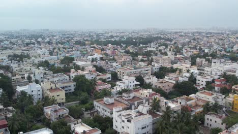 residential homes, apartments, vacant lands, and parks can be seen in an aerial video of an indian city