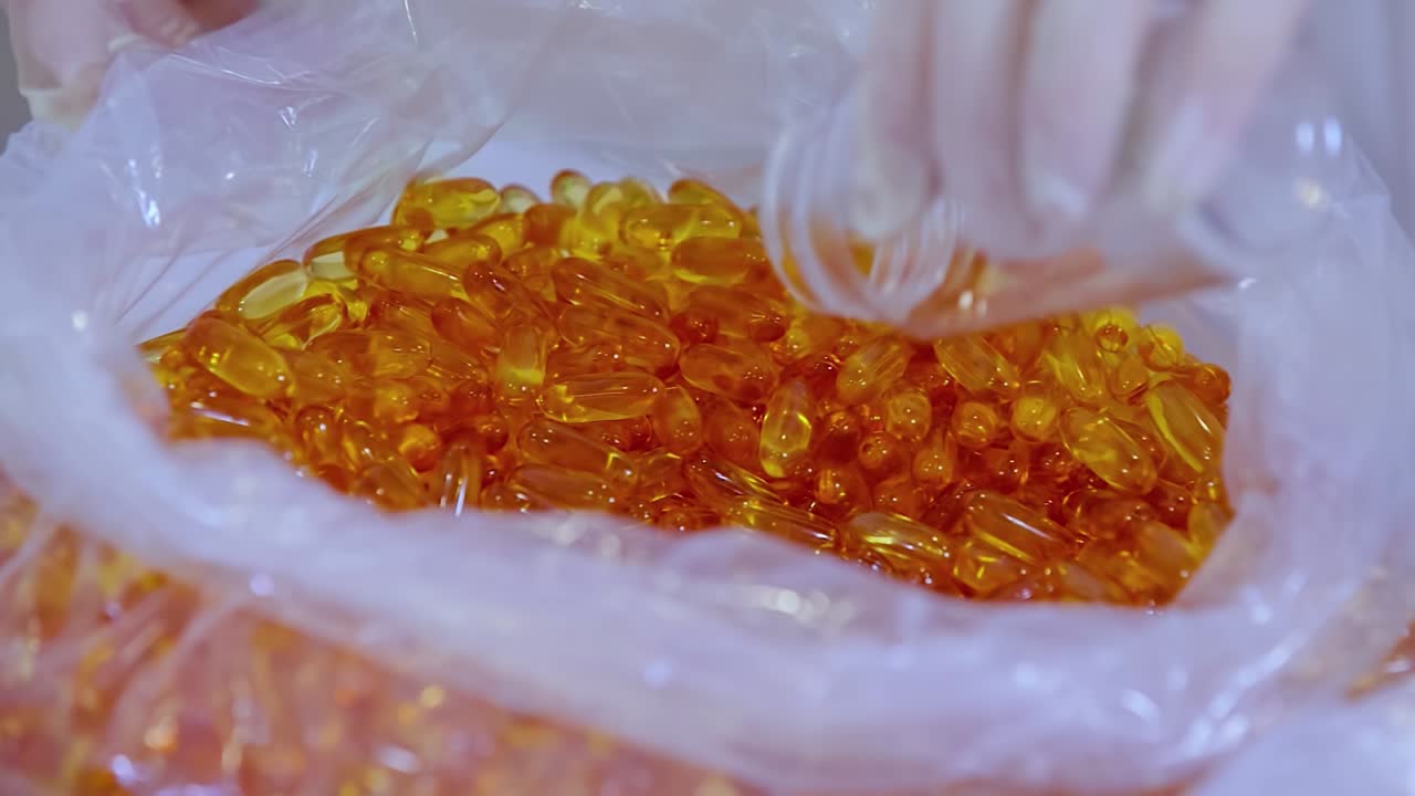 Coronavirus capsule medication batch. Close-up man packing pills into bottle