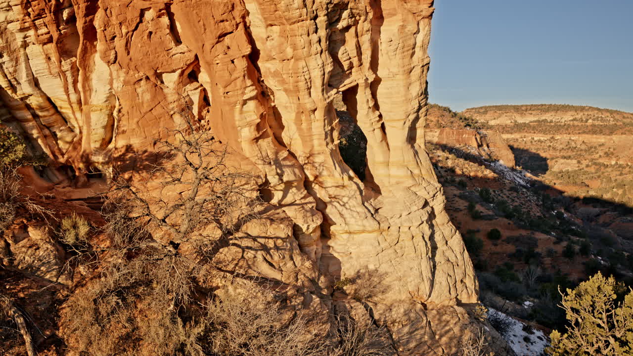 Sunrise drone view of a dramatic red rock arch near Kanab, Utah.