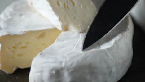camembert cheese with knife rotates slowly.