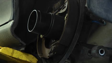 closeup of a mechanic works on a wheel repair