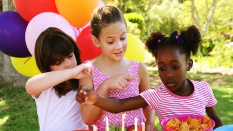 kids counting a food item in park