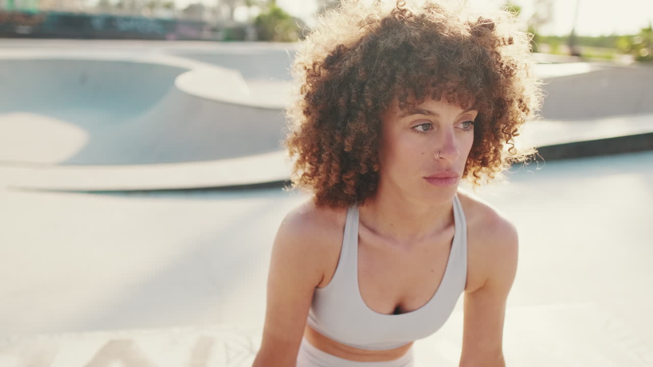 Fitness Woman Focuses on Wellbeing in Skate Park