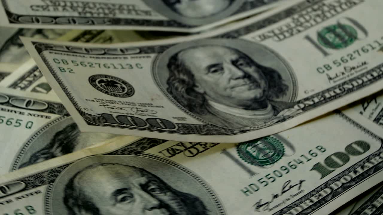 A lot of banknotes. Hundred American dollars banknotes, obverse side up, rotation on circle.