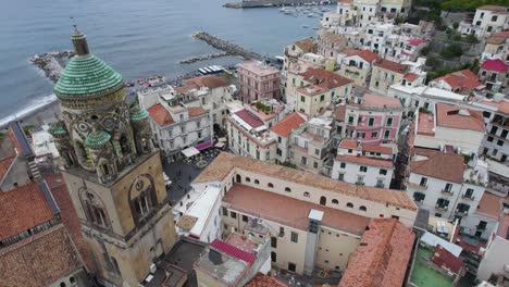 stunning architecture, clock tower, and city square market in amalfi italy, aerial