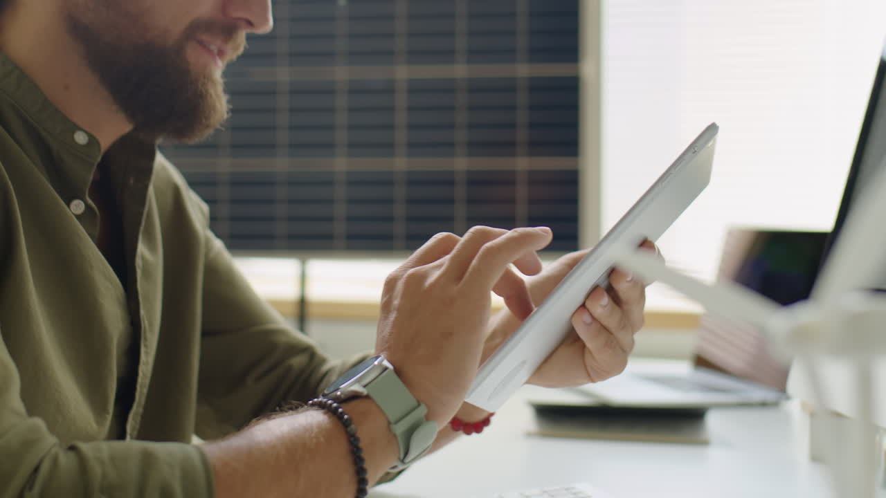 Man Using Tablet at Office Desk