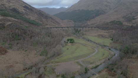 the historic glenfinnan viaduct amidst scottish highlands, overcast, aerial view