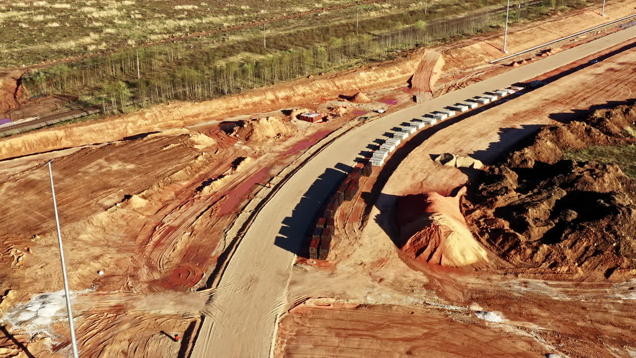 Aerial View of Railbed Construction Site With Materials and Equipment on Terrain
