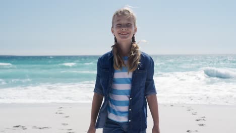 girl standing on the beach and looking at camera