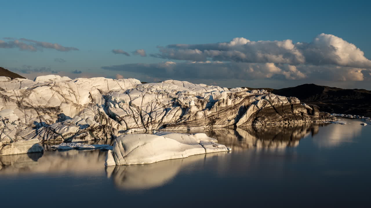 Svinafellsjokull Glacier Iceland Time Lapse. Moving Clouds Above Ice and Glacial Lake on Sunny Summer Day