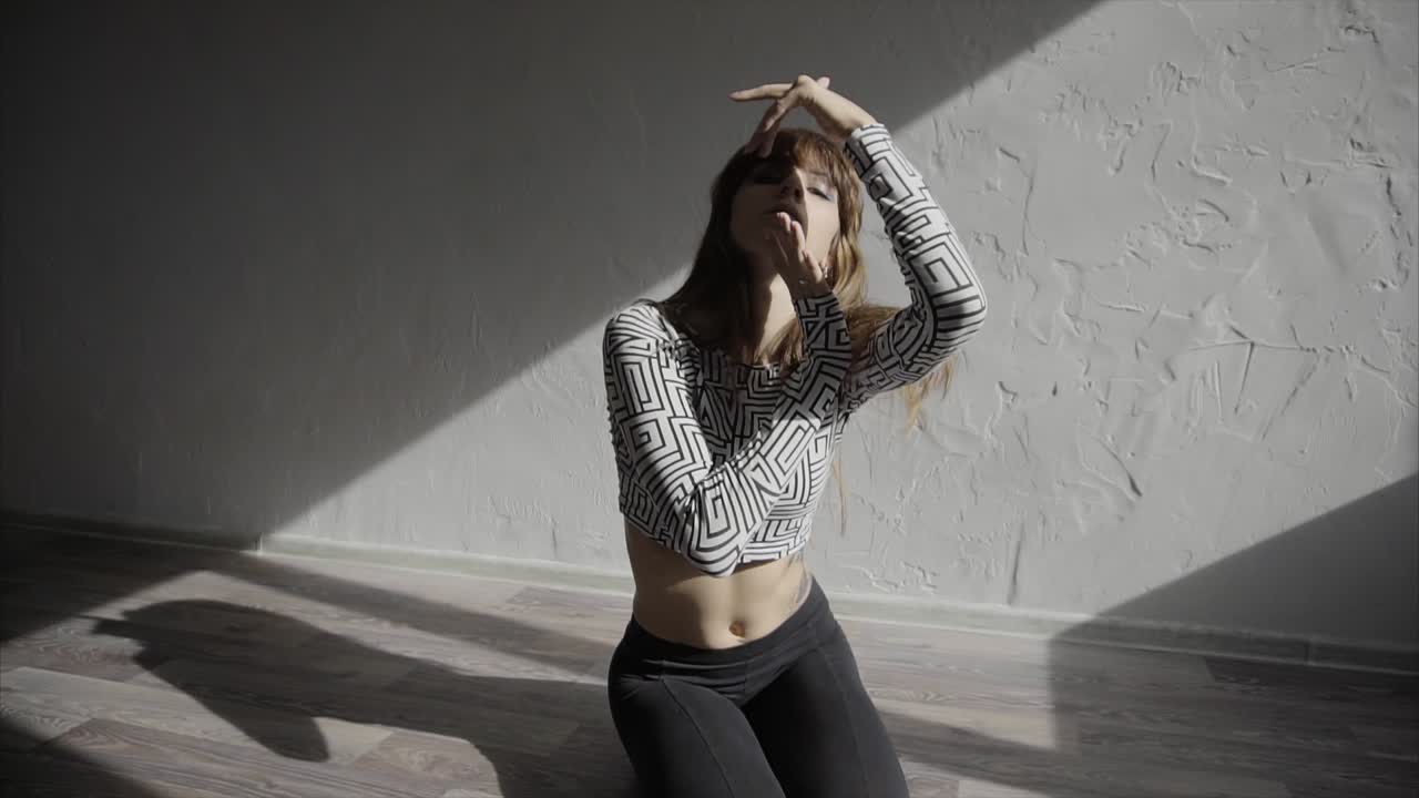 A Woman Dancing in a Studio