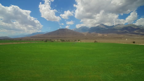 An-aerial-over-farmland-in-the-owens-valley-region-of-California-with-irrigation-lines-foreground-1