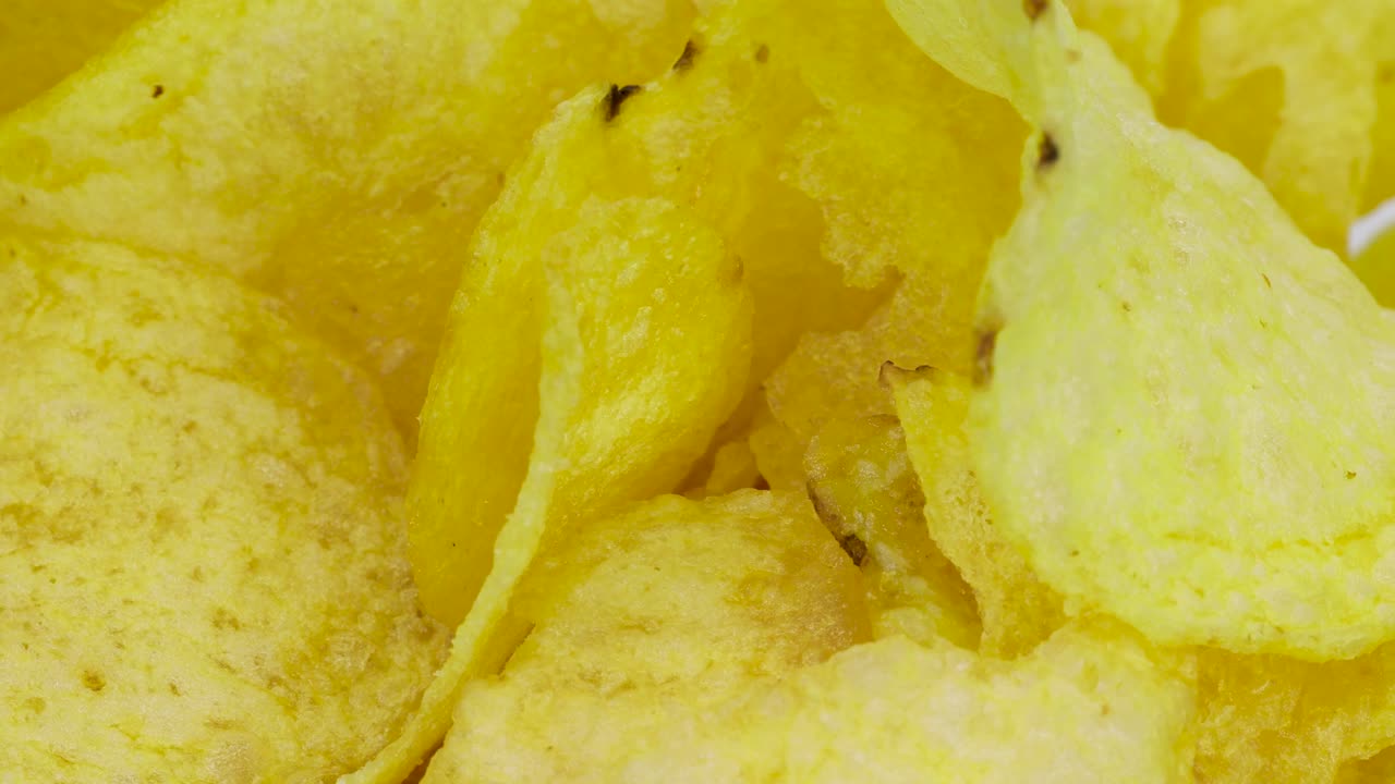 Golden potato chips very close up view, macro shot in 4k