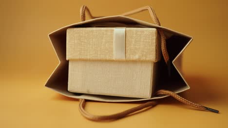 close-up of a brown gift bag with a brown gift box inside