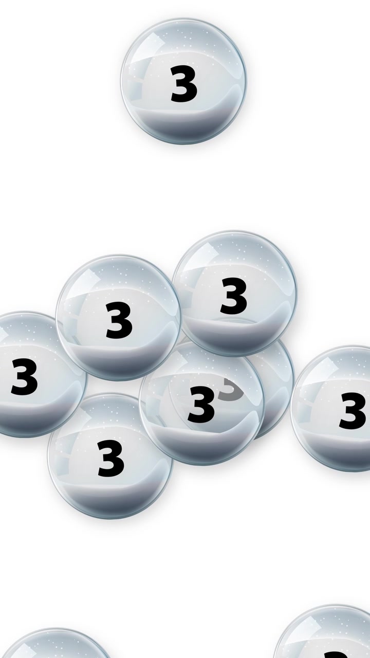 Transparent glass balls containing the number three fall vertically against a clean white studio background.