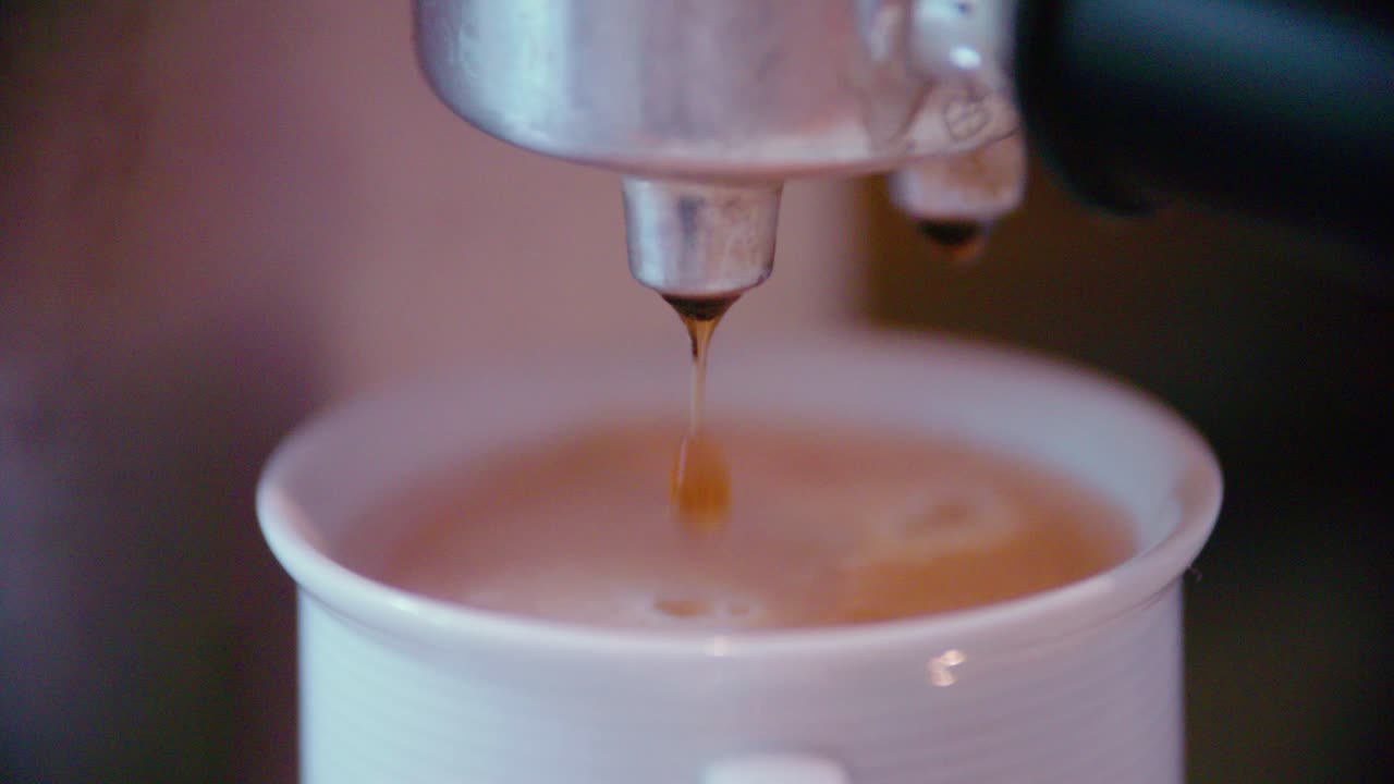 Coffeecup with espresso maker in slow motion