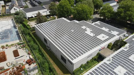 beautiful aerial overview of a rooftop filled with solar panels on an industrial building in belgium