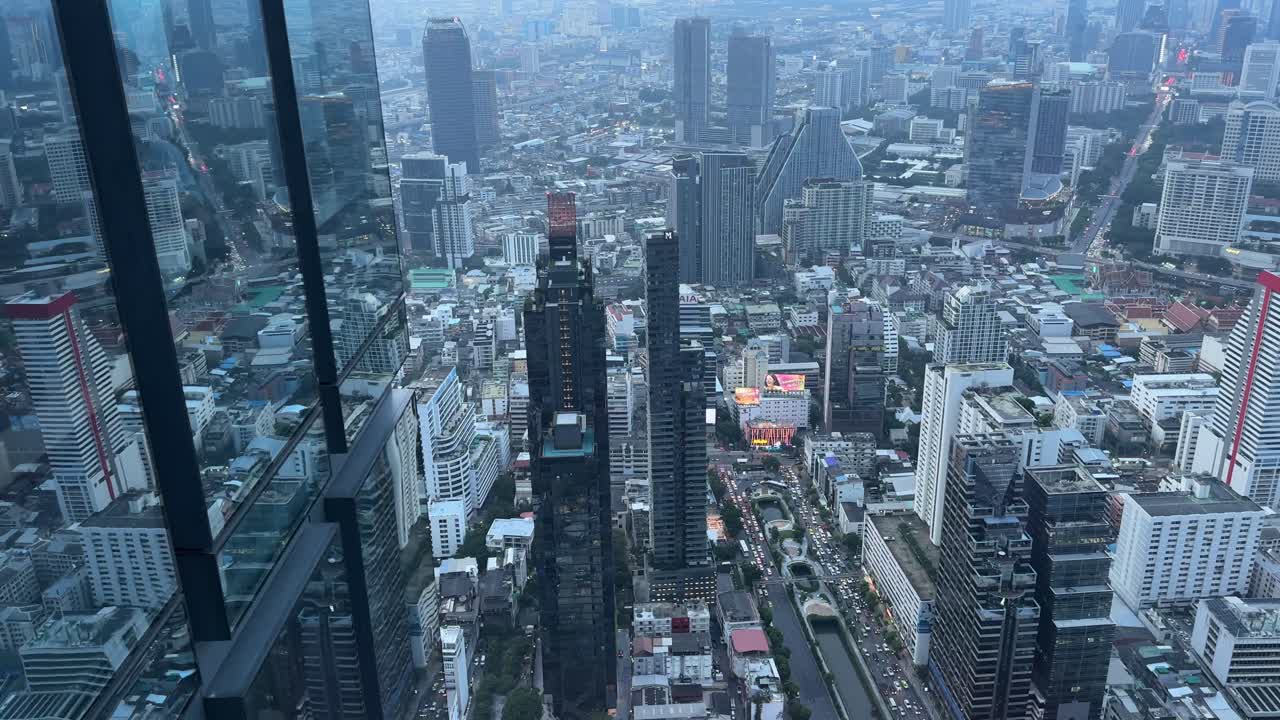 Aerial Mahanakhon glass skyscraper Bangkok city beyond - twilight no horizon, Thailand. Buildings over financial business district Downtown.