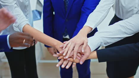 close-up, group of businessmen stands in a circle and puts their hand on hand, team unity. teamwork concept. 4k, prores