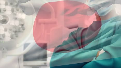 Animation-of-flag-of-japan-waving-over-surgeon-in-operating-theatre