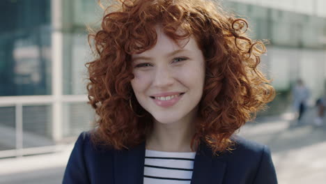 young red head business woman portrait smiling happy intern campus