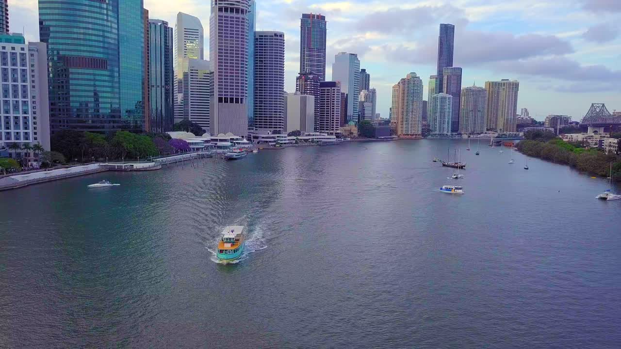 Front aerial view of Brisbane city ferry with high buildings in the background at daytime.