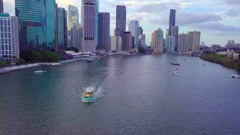 front aerial view of brisbane city ferry with high buildings in the background at daytime.