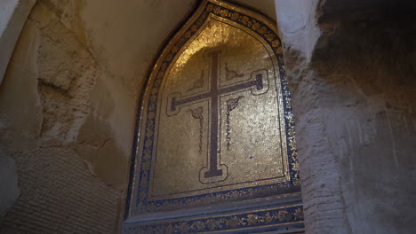 golden cross mosaic in an ancient building