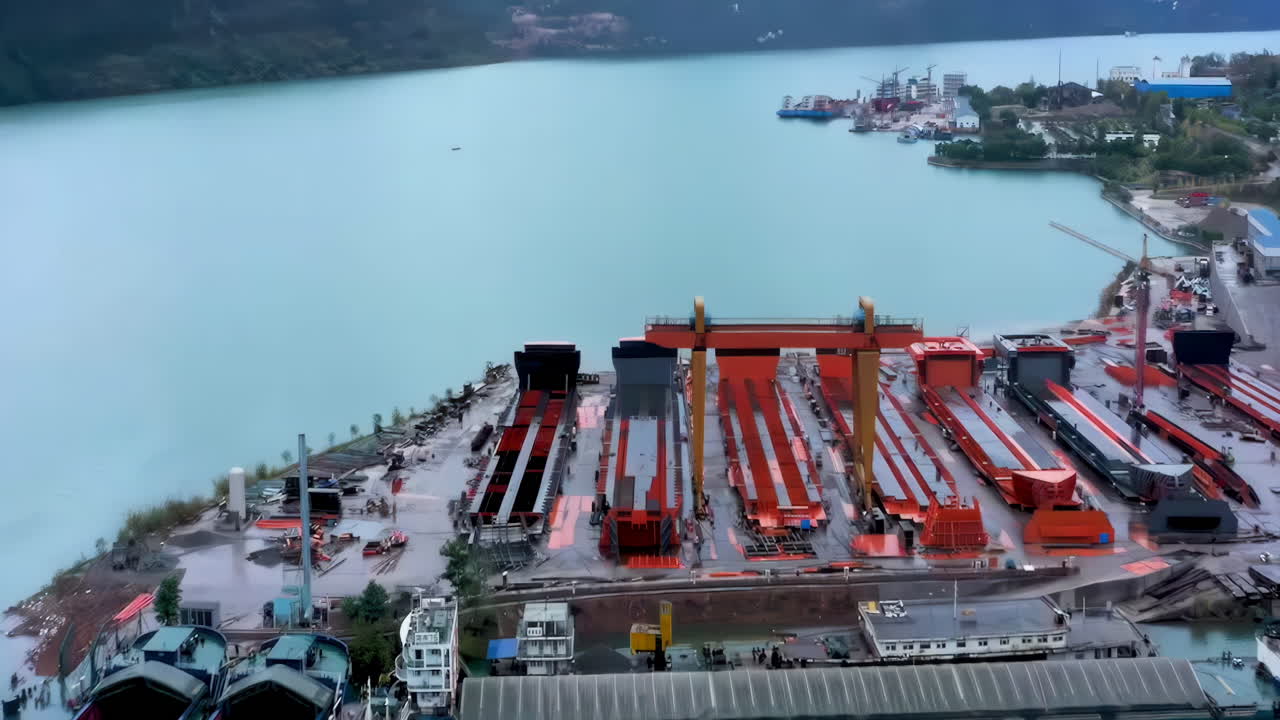 Industrial factory real shot of Shipbuilding and ship repair yard. Shipyard contains many cranes, dry docks, slipways, warehouses, painting facilities and large areas for fabrication of ships
