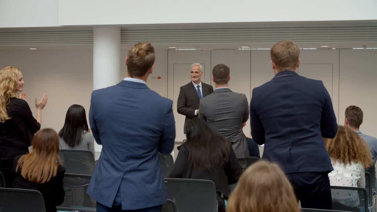Audience Applauding Speaker After Conference Presentation