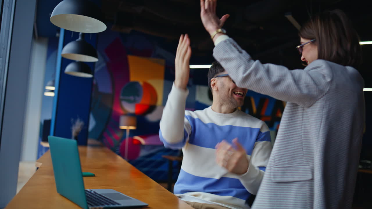 Creative workers looking laptop in bright office closeup. Designers rejoicing