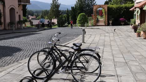 a bicycle moves across a paved courtyard area.